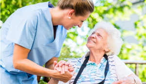 aged-care-worker-holding-senior-womans-hand